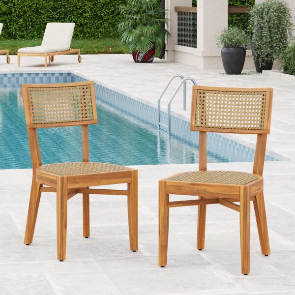 Acacia wood and light brown plastic rattan dining chairs beside a swimming pool.