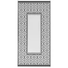 Light side of a black and white outdoor rug with a floral border and plain rectangular center.