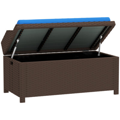 Brown wicker storage bench with its cushioned lid open, showing the interior compartment and a blue seat cushion.