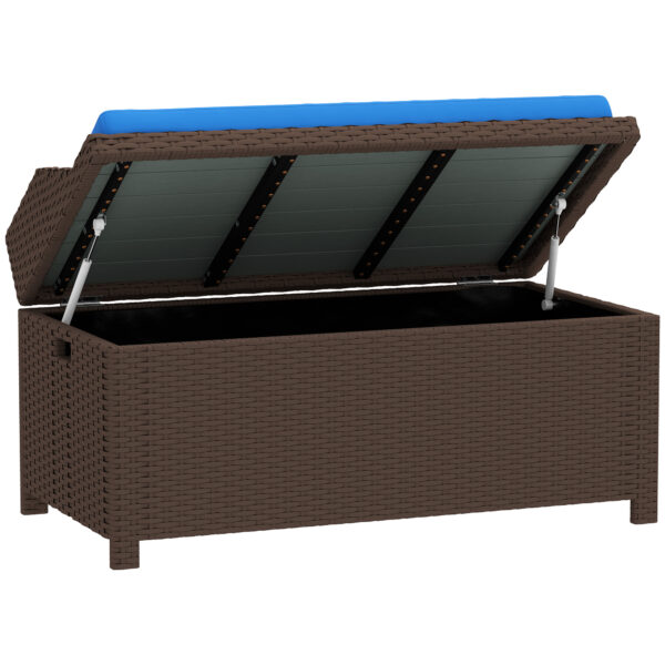 Brown wicker storage bench with its cushioned lid open, showing the interior compartment and a blue seat cushion.