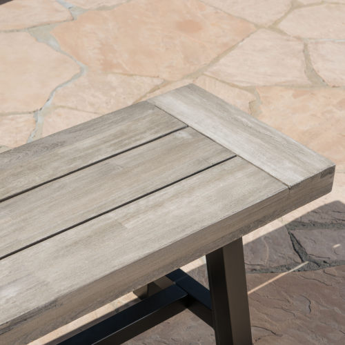 Close-up of the light gray acacia slats and dark metal frame