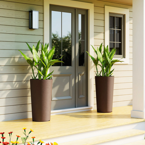 Matching brown planters positioned on either side of a porch doorway; plants shown for styling.