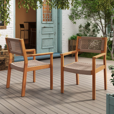 Two acacia wood dining armchairs with light brown rope seats and backs, shown in an outdoor setting.