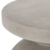 Close view of the side table round top and light gray textured surface.